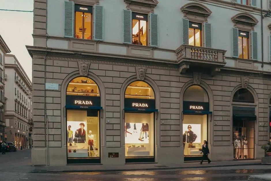A stylish view of a Prada store facade in Florence, Italy, during evening hours.