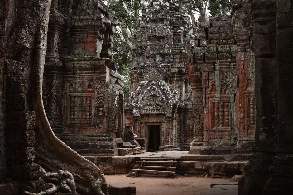 Explore the intricate carvings of an ancient Khmer temple, nestled in lush Cambodian surroundings.